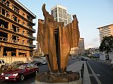 Beirut Corniche 10 A Sculpture Of A Flame Called The Torch Sits Next To The Bombed Out St Georges Hotel With Platinum Tower Behind